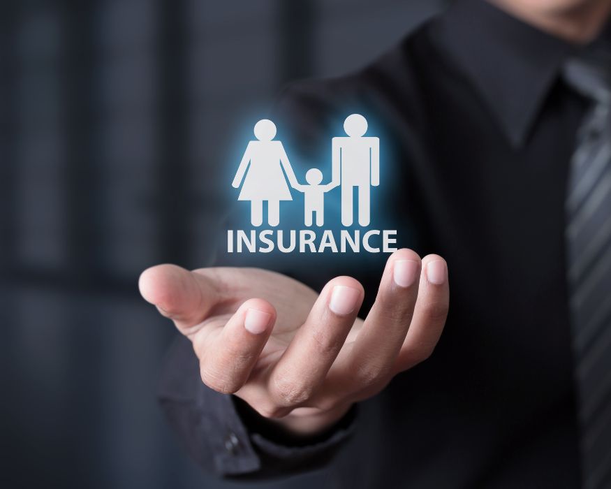 An outstretched hand displays a glowing family insurance icon, symbolizing support and coverage for patients and their loved ones.